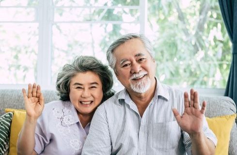 senior-couple-say-hi-look-camera